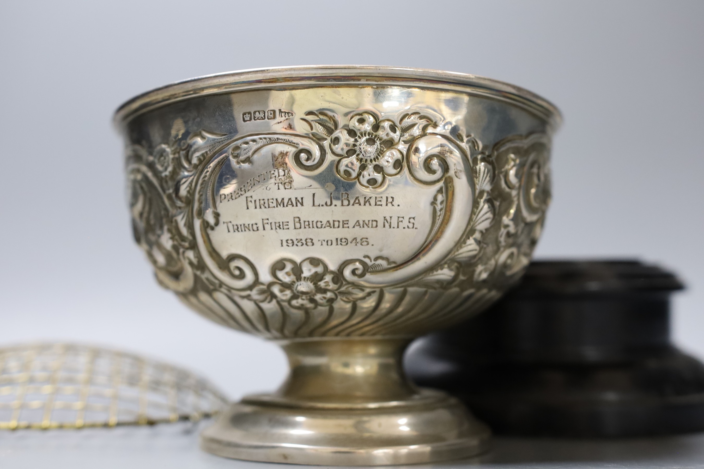 An Edwardian repousse silver rose bowl, with later engraved inscription, diameter 16.6cm, 9.5oz, on ebonised socle.